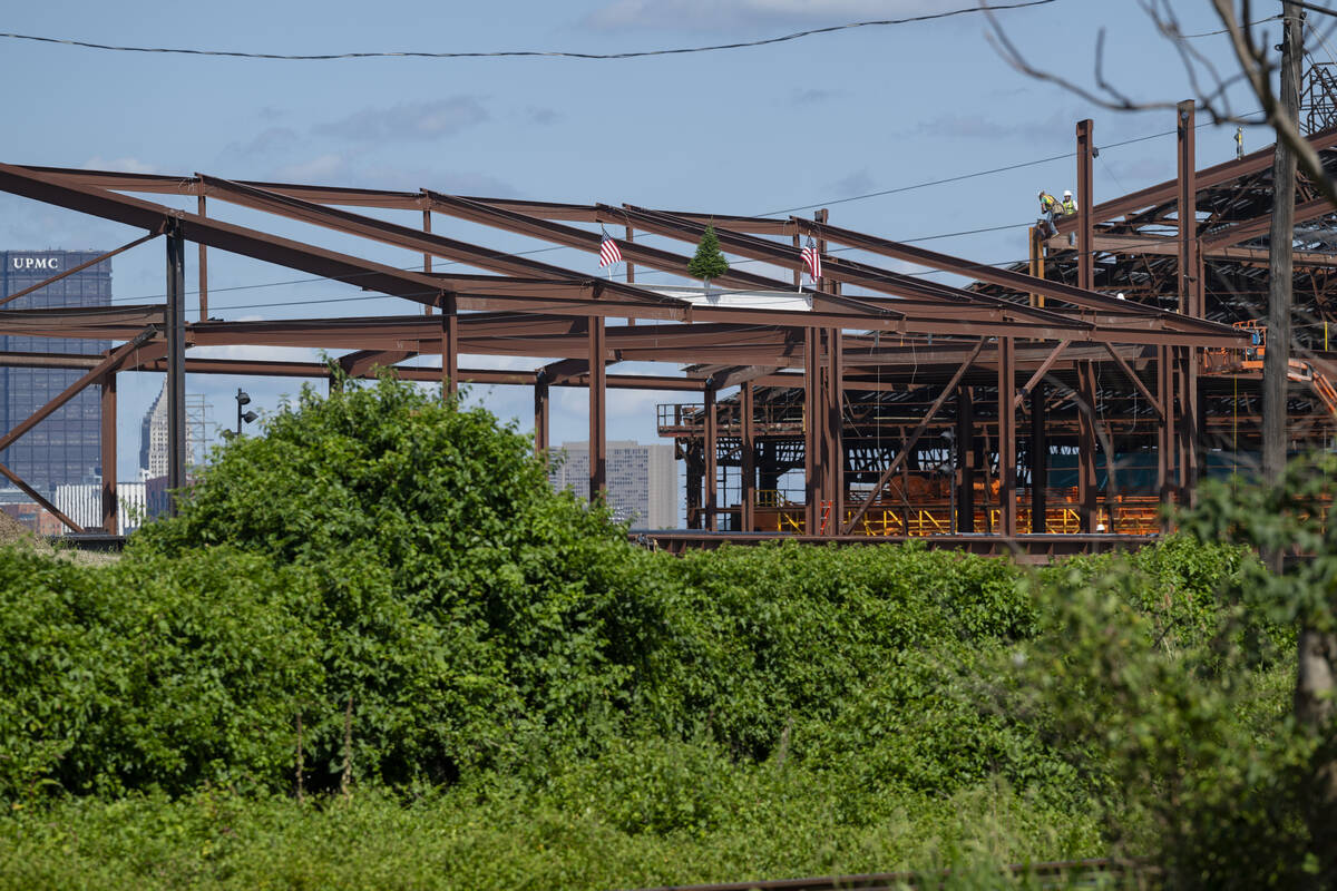 Steel beams that make the structure of the RIC rise up into a blue sky.
